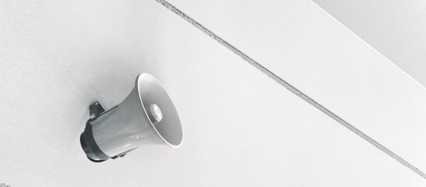 gray megaphone on white surface