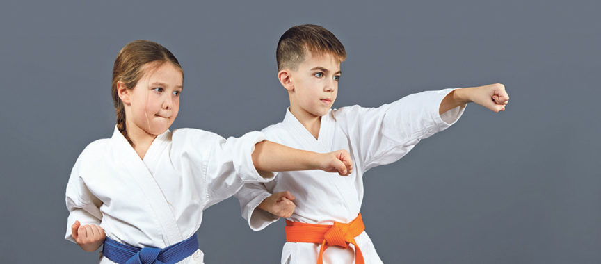 Two athletes are training blow the hand on a gray background